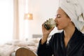 White woman wrapped towel drinking water after shower Royalty Free Stock Photo