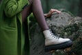 White womans boot, green coat. Woman posing in a forest Royalty Free Stock Photo