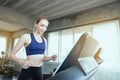 White women are exercising on exercise machines. Young people running on treadmill in gym. Young caucasian exercising on a Royalty Free Stock Photo