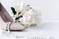 white womens boat Shoe, pearl, necklace, flower, hydrangea, shoes Royalty Free Stock Photo