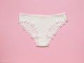 White women`s cotton lace panties on a pink background. Women`s underwear Royalty Free Stock Photo
