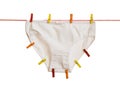 White women`s panties with multi-colored clothespins on a rope isolated on a white background. Royalty Free Stock Photo