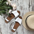 White women`s sandals on wooden background Royalty Free Stock Photo