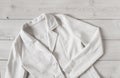 White women`s short linen jacket with buttons and long sleeves.