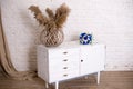 White wood bedside table, dresser in bedroom. bridal bouquet on the nightstand vase with flowers. interior. Series of