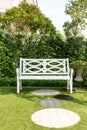 White wood bench chair with bush Background in garden at home. Royalty Free Stock Photo