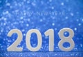 2018 white wood numbers on blue paper with glitter lights Royalty Free Stock Photo