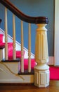White wood staircase with tapered newel post