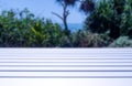 White Wood Table with Blurred Beach at Background