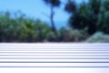 White Wood Table with Blurred Beach at Background