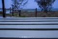 White Wood Table with Blurred Beach at Background