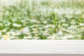 White wood table top on blur camomile field background Royalty Free Stock Photo