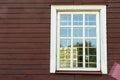 White wooden antique window on a wooden building. Old well-kept wooden house. Old Church and Windows with a cross Royalty Free Stock Photo