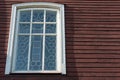 White wooden antique window on a wooden building. Old well-kept wooden house. Old Church and Windows with a cross Royalty Free Stock Photo