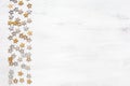 White wooden  background with Christmas decorations in a rustic style. Silver and golden stars on old wooden background with copy Royalty Free Stock Photo