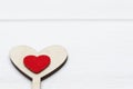Two hearts, red and wooden, on white wooden background. Valentine`s day or Love concept. Royalty Free Stock Photo