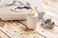 Bottle with weight loss pills, scales and measuring tape on white wooden background Royalty Free Stock Photo