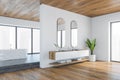 White and wooden bathroom with bathtub and sinks with mirrors Royalty Free Stock Photo