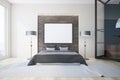 White and gray bedroom, fireplace and poster