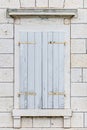 White wooden blinds on old stone building window