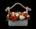 White wooden box filled with white and red roses and ripe strawberries isolated on black background Royalty Free Stock Photo