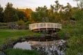 White wooden bridge over small calm river Royalty Free Stock Photo