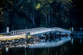 White wooden bridge reflected in a dark waters of Wallaga Lake, NSW, Australia