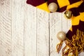 White wooden Christmas background. Empty space for text. Happy New Year. Christmas balls, garland, brown-red scarf Royalty Free Stock Photo