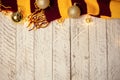White wooden Christmas background. Empty space for text. Happy New Year. Christmas balls, garland, brown-red scarf Royalty Free Stock Photo