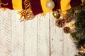 White wooden Christmas background. Empty space for text. Happy New Year. Christmas balls, garland, brown-red scarf Royalty Free Stock Photo