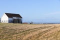 A white wooden cottage in a field Royalty Free Stock Photo