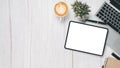 White wooden desk workplace with blank screen tablet, laptop, pen, notebook and cup of coffee, Royalty Free Stock Photo