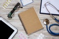 White wooden desktop with office and medical objects on it. Royalty Free Stock Photo