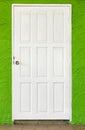 White wooden door in green concrete wall Royalty Free Stock Photo