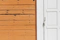 A white wooden door with its frame on the vintage gray and orange stripe color Royalty Free Stock Photo
