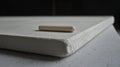 A white wooden dowel on a white surface. Royalty Free Stock Photo