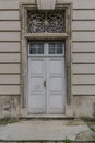 White wooden enterance door. Old Elegant Double door with decor keystone on top