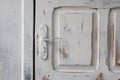 White wooden entrance door with door handle. The paint on the do Royalty Free Stock Photo