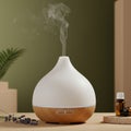 A white and wooden essential oil diffuser emits a thin stream of mist. Its teardrop shape Royalty Free Stock Photo