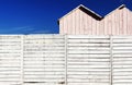 A white wooden fence with some booths Royalty Free Stock Photo