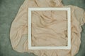 The white wooden frame arranges the elements on the fabric Royalty Free Stock Photo