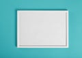 White wooden frame for painting or picture on green background Royalty Free Stock Photo