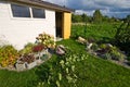 White wooden garden shed or hut with flowers and plants Royalty Free Stock Photo