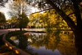 White wooden gazebo on a picturesque lake in the Park at sunset. Royalty Free Stock Photo