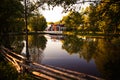 White wooden gazebo on a picturesque lake in the Park at sunset. Royalty Free Stock Photo