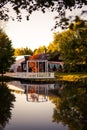 White wooden gazebo on a picturesque lake in the Park at sunset. Royalty Free Stock Photo