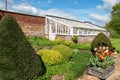 White wooden greenhouse in an English country manor house garden. Royalty Free Stock Photo