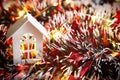 White wooden house with Christmas decorations, red tinsel and Golden lights garlands. New year, comfort, home warmth, cozy. Christ