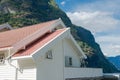 white wooden house with red roof near beautiful mountains at Aurlandsfjord Flam Royalty Free Stock Photo