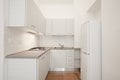 White wooden kitchen with gray stone top in renovated apartment Royalty Free Stock Photo